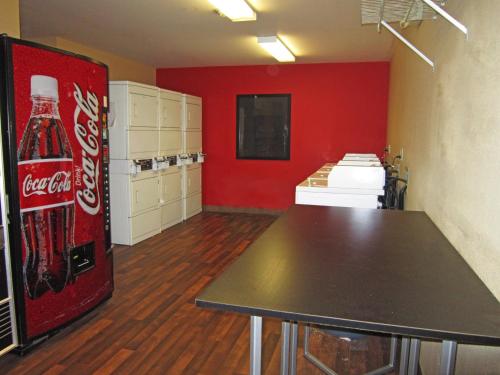 a room with a coca cola refrigerator and a table at Extended Stay America Suites - Tacoma - Fife in Fife