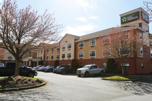 a parking lot with cars parked in front of a building at Extended Stay America Suites - Tacoma - Fife in Fife