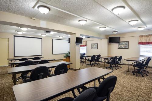 a conference room with tables and chairs and a projection screen at Quality Inn Winchester in Winchester