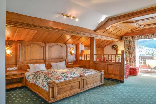 a bedroom with a large wooden bed in a room at Doerr Landhotel & Spa in Bad Laasphe