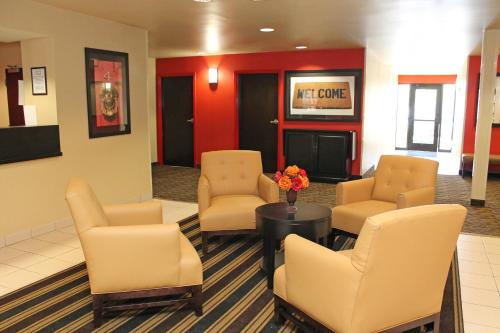 a waiting room with chairs and a table and flowers at Extended Studio Hotel Suites - Los Angeles - San Dimas in San Dimas