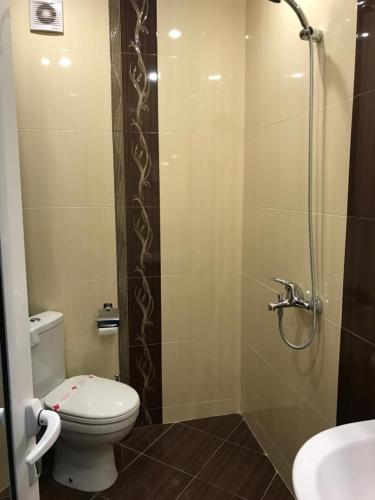 a bathroom with a shower with a toilet and a sink at Hotel Body M in Vratsa
