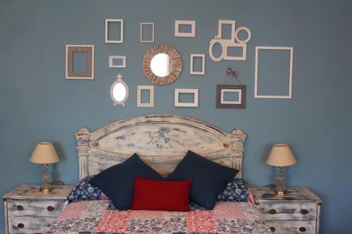 a bedroom with a bed with pictures on the wall at Hostal-Restaurante Fogón de Gredos in Guisando