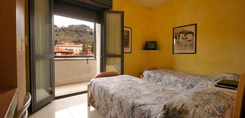Кровать или кровати в номере Albergo Giardinetto