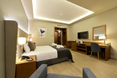 a hotel room with a bed and a desk at Holiday Inn Bursa - City Centre, an IHG Hotel in Bursa