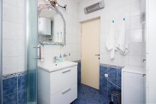 a bathroom with a sink and a shower at Apartment Luce in Split