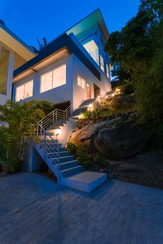 a house with stairs and lights in front of it at Villa Melo in Chaweng Noi Beach