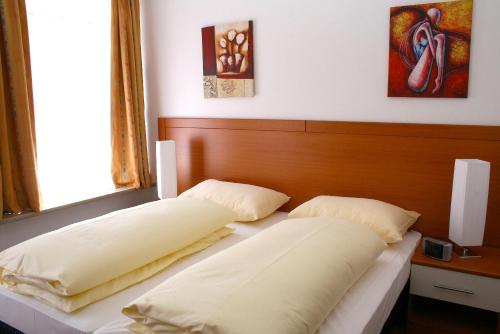 
Ein Bett oder Betten in einem Zimmer der Unterkunft Hotel Evido Salzburg City Center
