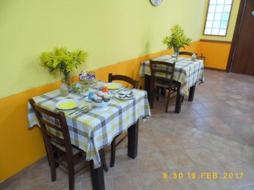 a dining room with two tables and two chairs at Agriturismo Primaluce in Sorrento