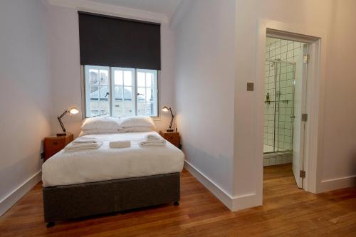 a bedroom with a large bed and a window at Green Rooms in London