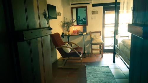 a room with a chair and a table in a room at Irene's House in Kakopetria