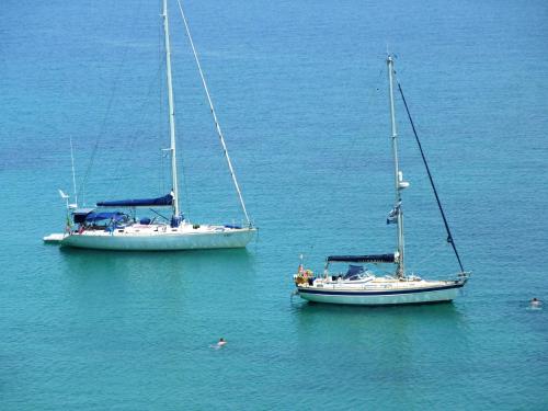 two boats sitting in the water next to each other at Hotel Perama in Perama