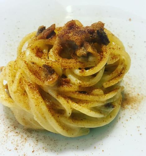 a pile of spaghetti on a white plate at B&B Antico Brolo in Gardone Riviera