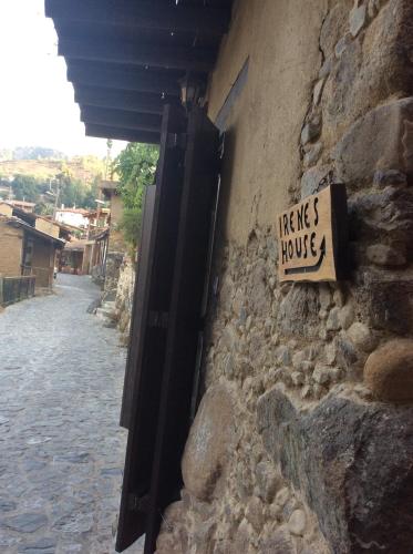 a sign on the side of a stone building with a sign at Irene's House in Kakopetria