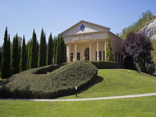 a building with a sign in front of a yard at Première Classe Metz Nord - Talange in Talange
