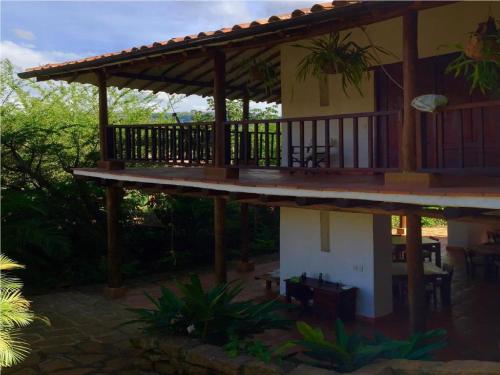 a house with a deck and a patio at Achiotte by Masaya Collection in Barichara