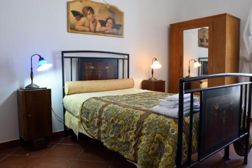 a bedroom with a bed and two lamps and a mirror at Villa Elide in Ginosa Marina