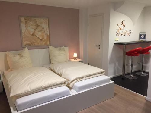 a bed with two white pillows in a room at Apartment Ardi in Filderstadt