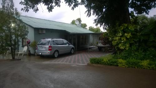 a van parked in front of a house at Gloria's Bed and Breakfast in Livingstone