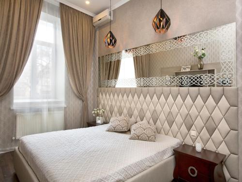 a bedroom with a bed and two pillows on it at City Garden Apartments in Odesa