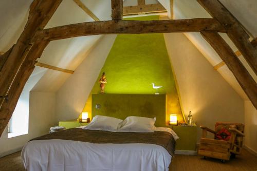 a bedroom with a large bed in an attic at Alex Factory Gites et Chambres d'hôtes Côte d'Opale in Wierre-Effroy