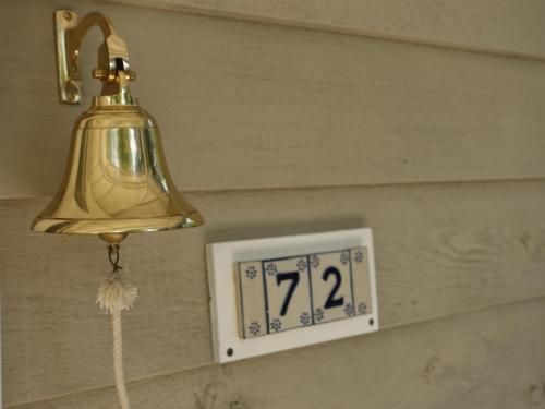 a clock on a wall next to a lightswitch at Winston Cottage in Palmwoods