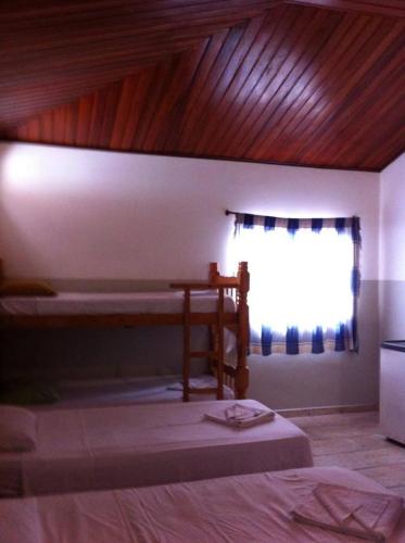 a bedroom with a bed and a window with a window at Oriental Hotel in Sorocaba