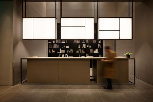 a person walking in front of a counter with lights at Shilla Stay Seocho Gangnam Station in Seoul