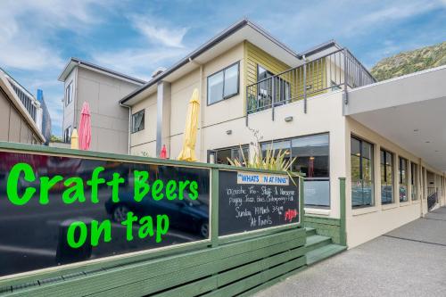 a restaurant with a sign that reads craft beers on tap at Finns Paekakariki in Paekakariki