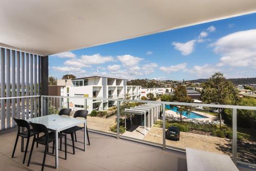 a view from the balcony of a apartment with a table and chairs at Coast Resort Merimbula in Merimbula