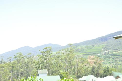 a view of the hills from a house at Forest View Lodge in Nuwara Eliya