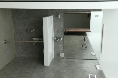 a bathroom with an open door to a shower at The Grand Yala Hotel in Tissamaharama