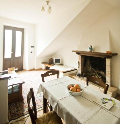 a dining room with a table and a fireplace at Borgo San Valentino in Arrone