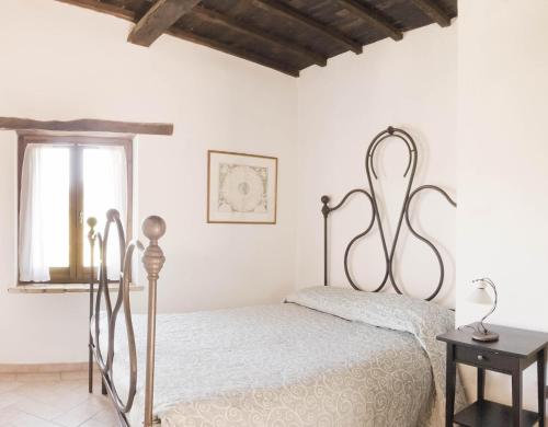 a white bedroom with a bed and a window at Borgo San Valentino in Arrone