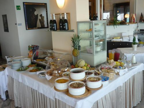 a table with a buffet of food on it at Hotel Marea in Grado