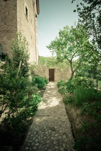 a stone path leading to a building with a door at Borgo San Valentino in Arrone