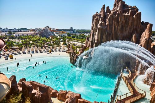 a water park with people in a wave pool at The Land Of Legends Kingdom Hotel - All-in Concept in Belek
