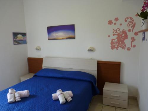 a bedroom with two towels on a bed at Residence Costablu in Rimini