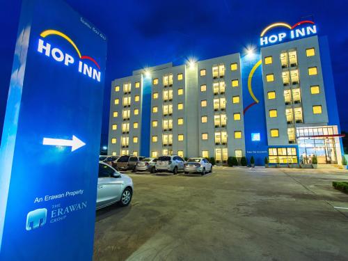 a hop inn sign in front of a parking lot at HOP INN Khon Kaen Srichan Road Building A in Khon Kaen