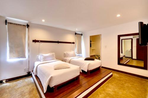 
a hotel room with two beds and a television at Chen Sea Resort & Spa Phu Quoc in Phú Quốc
