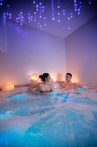 a man and a woman in a hot tub at Borgo Medievale in Castelmola