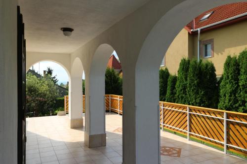 an external view of a house with arches at Napfény villa in Balatonfüred