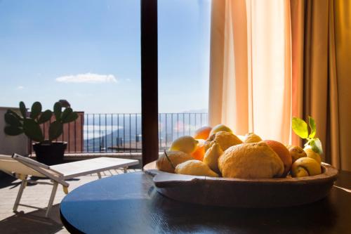 a bowl of fruit on a table in a room with a window at Borgo Medievale in Castelmola