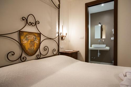 a bedroom with a large bed and a sink at Borgo Medievale in Castelmola