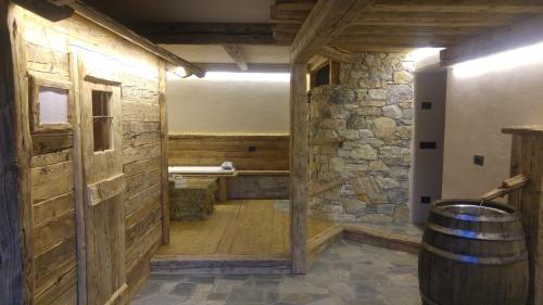 a room with a barrel and a wooden wall at Chalet Teo e Marianna in Bormio