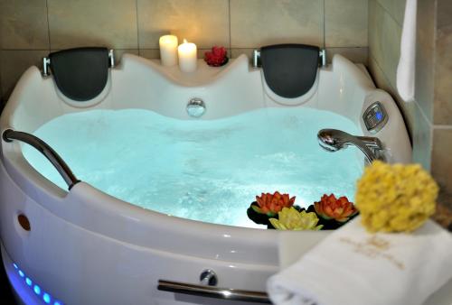 a bath tub filled with water in a bathroom at Konitsa Mountain Hotel in Konitsa