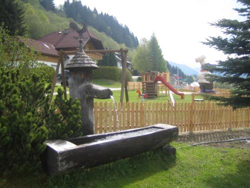 a statue of a bath tub with a water fountain at Landhotel Stofflerwirt in Sankt Michael im Lungau