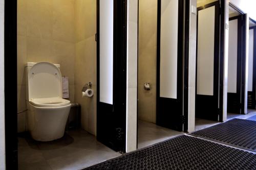 a bathroom with a toilet in a stall at Clock Inn Dehiwala in Mount Lavinia