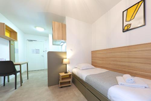 Posteľ alebo postele v izbe v ubytovaní Apparteo Dijon