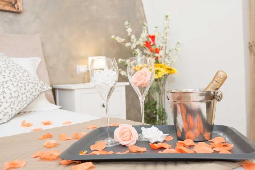 a tray with two champagne glasses and roses on a table at Chiaia Suites in Naples